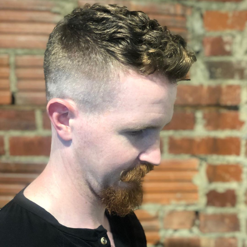 Clipper cut fade with textured hair on top
